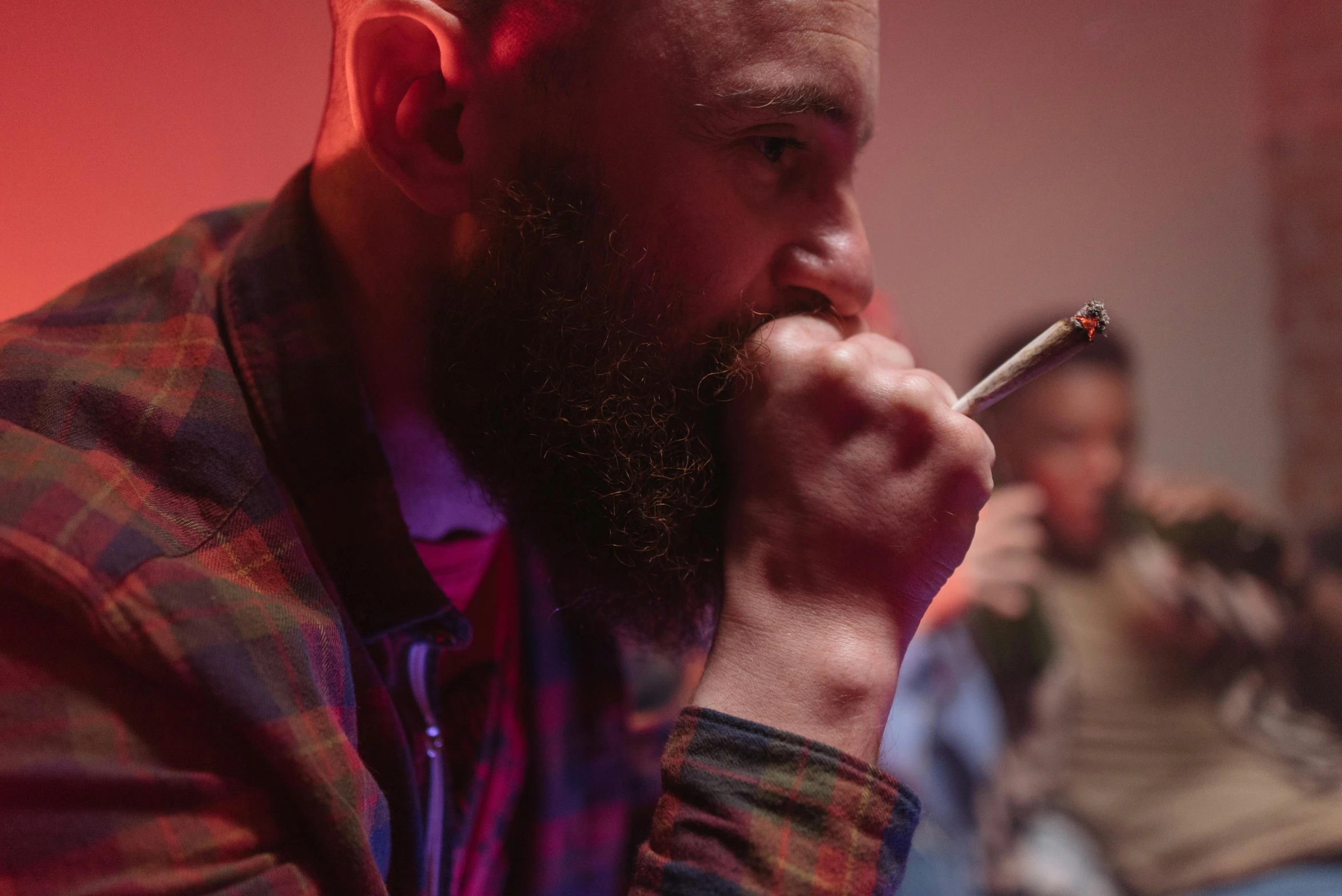 a man with a beard smoking a cigarette, pexels contest winner, hyperrealism, cinematic red lighting, mac miller, person in foreground, film still dnd movie