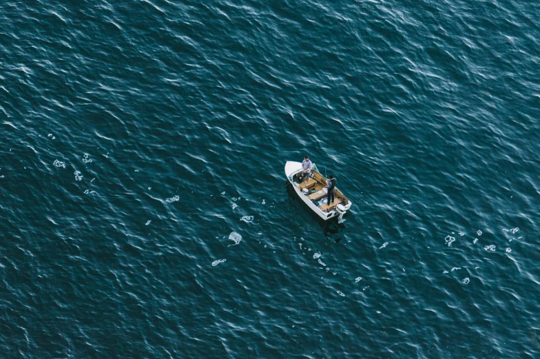 a small boat in the middle of a large body of water, by Elsa Bleda, pexels contest winner, down there, fisherman, movie film still, thumbnail