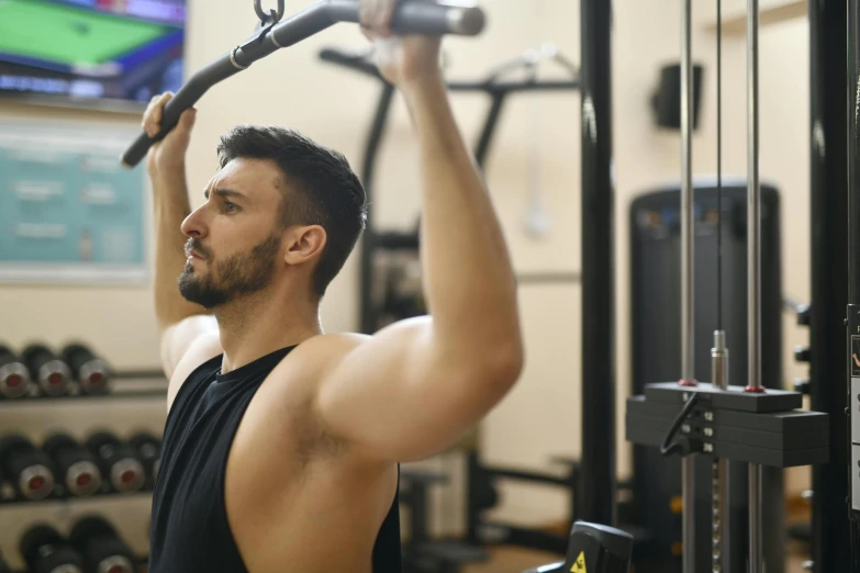 a man using a pull up bar in a gym, a portrait, pexels contest winner, renaissance, 30 year old man :: athletic, profile image, no - text no - logo, upper body image