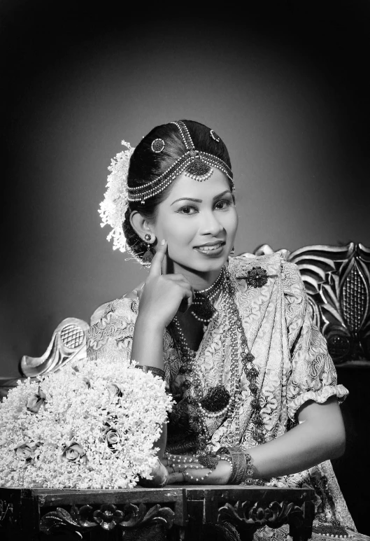 a black and white photo of a woman sitting in a chair, a black and white photo, inspired by T. K. Padmini, hurufiyya, wedding, sri lanka, traditional female hairstyles, !!!!