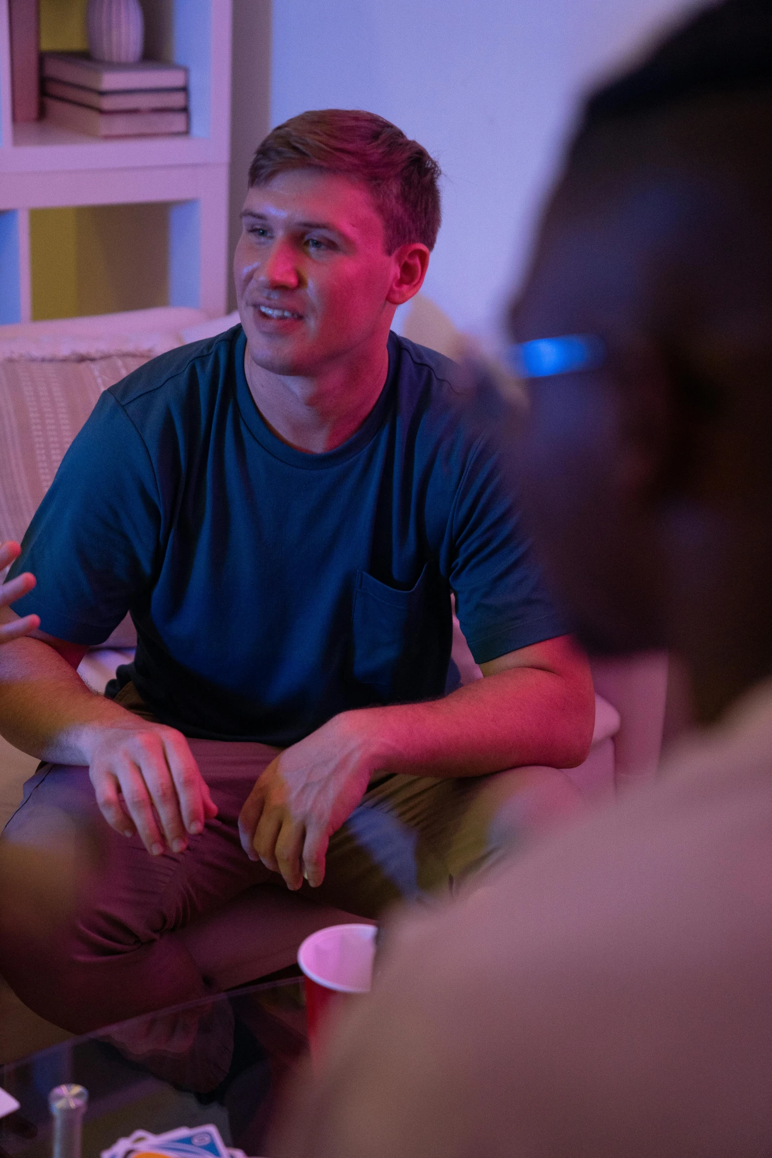 a group of people sitting on a couch in a living room, male with halo, emmanuel shiru, white male, transparent