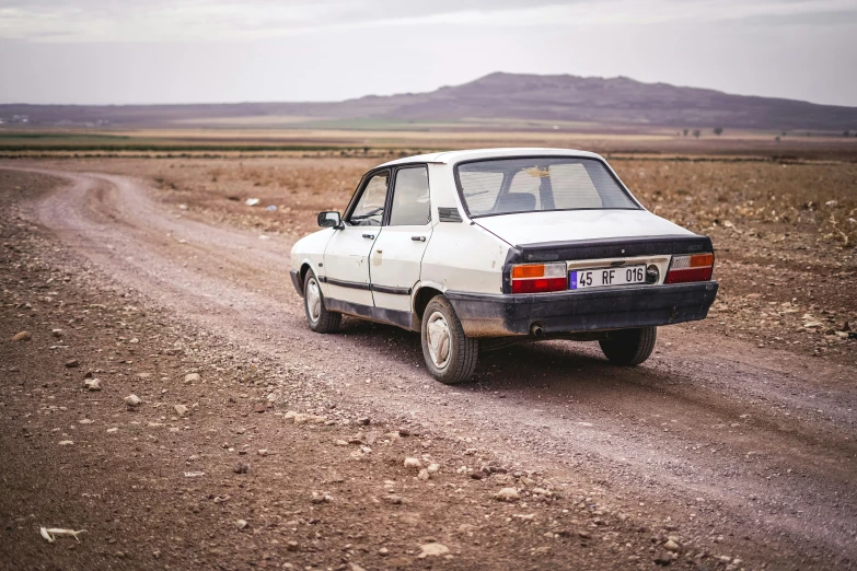 a white car driving down a dirt road, les nabis, 80s nostalgia, square, high quality photo, rojava