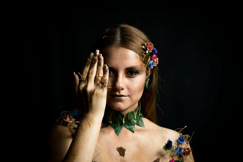 a woman with tattoos holding her hands to her face, an album cover, by Lucia Peka, unsplash, renaissance, made of dried flowers, bodypainting, made of bronze, poison ivy