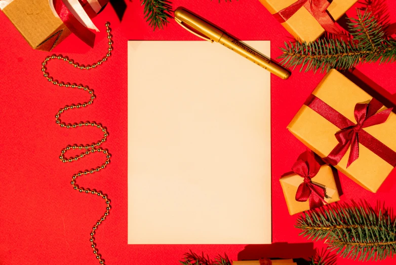 a christmas card surrounded by presents on a red background, pen and paper, background image, gold accessories, thumbnail