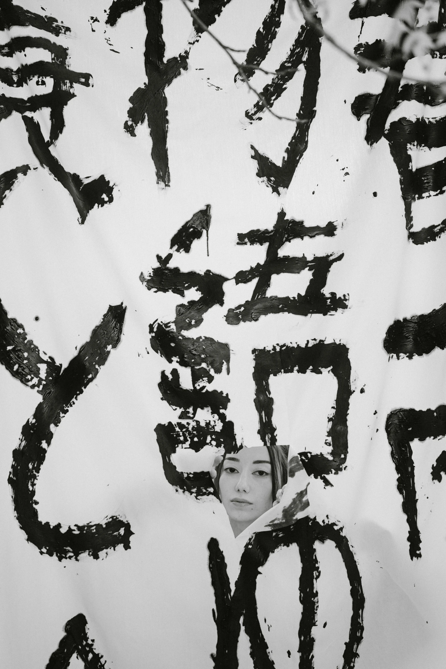 a close up of a sign with writing on it, an album cover, inspired by Taro Yamamoto, unsplash, fluxus, chinese woman, damaged japanese clothes, monochrome, asemic writing