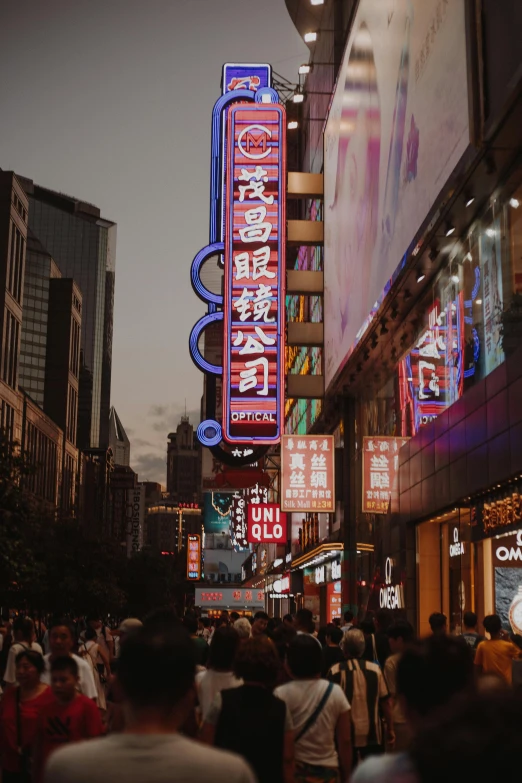 a crowd of people walking down a street next to tall buildings, neon signs, chinese, high-quality photo, billboard image