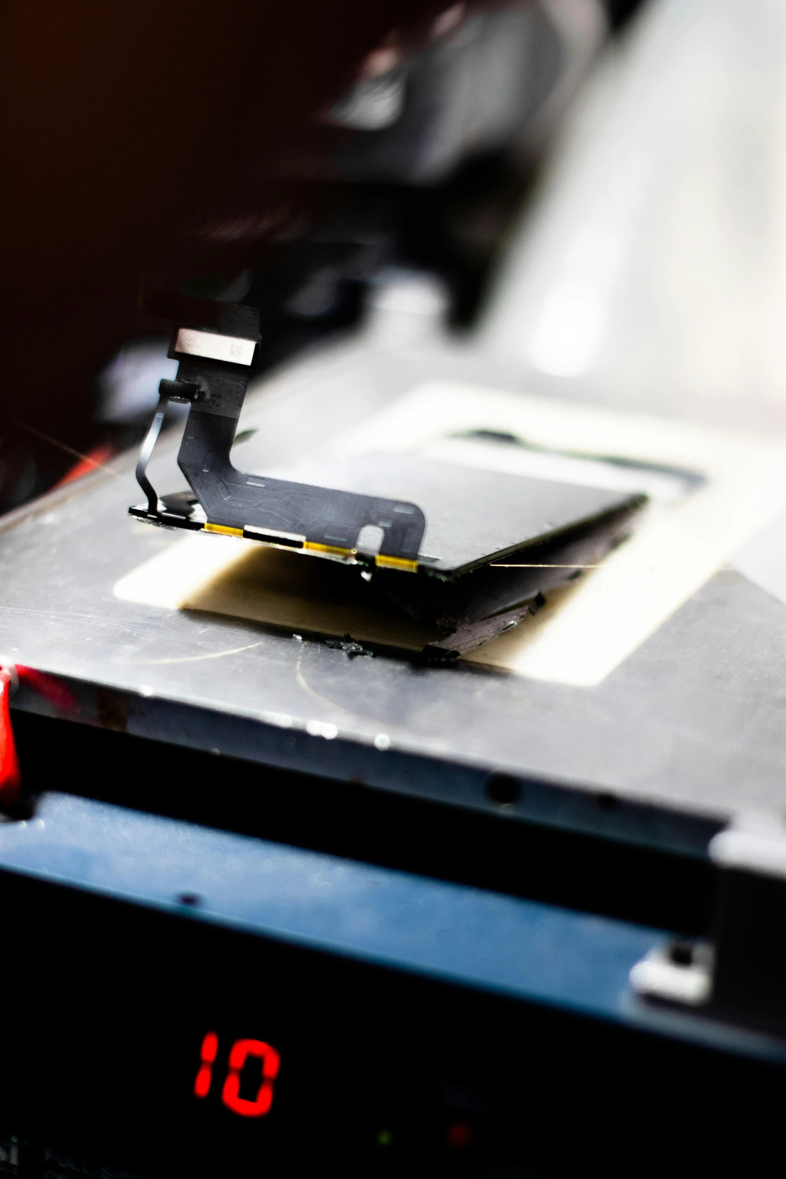 a close up of a clock on a table, by Daniel Lieske, happening, modular graphene, camera looking down into the maw, oled, inspect in inventory image