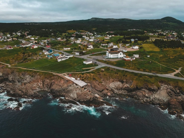 an aerial view of a small town next to the ocean, by Brian Snøddy, pexels contest winner, francois legault, family photo, coast as the background, tiffany dover