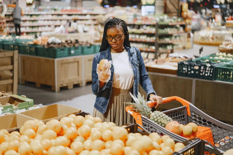 a woman holding a donut in a grocery store, pexels contest winner, wearing an orange t-shirt, beautiful city black woman only, avatar image, fruit