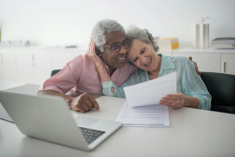 a couple of people sitting at a table with a laptop, older woman, multiple stories, thumbnail, healthcare