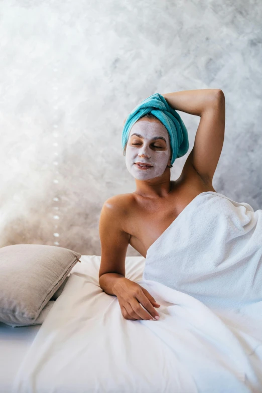 a woman laying in bed with a towel on her head, a portrait, trending on pexels, renaissance, face mask, full-body, holiday, silicone skin