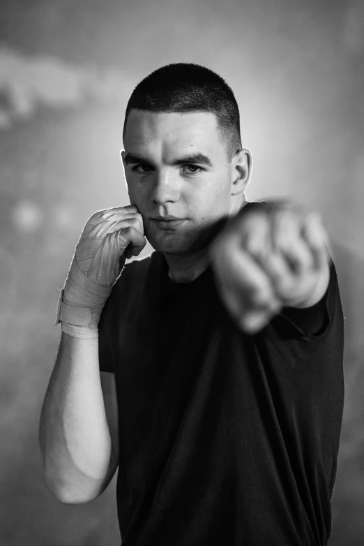 a man is posing for a black and white photo, by Daniel Gelon, photorealism, in a fighting stance, ben shapiro, promotional image, square