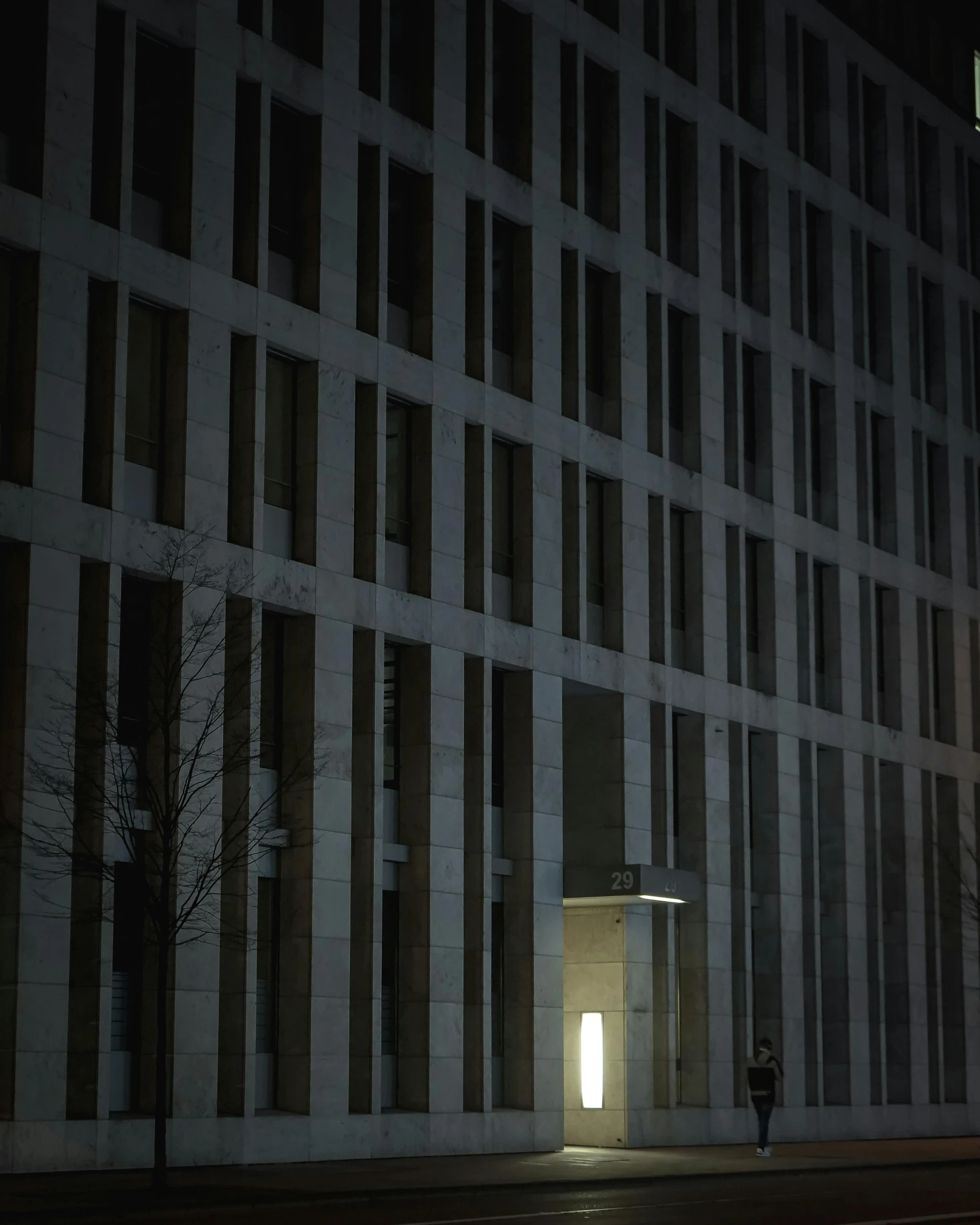 a street light in front of a building at night, inspired by David Chipperfield, wim crouwel, alessio albi, ((monolith)), trending photo