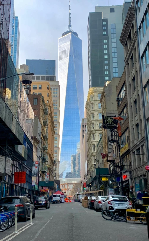 a city street filled with lots of tall buildings, world trade center twin towers, photo taken in 2018, full of reflections, market street