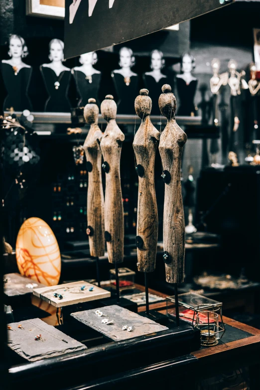 a group of mannequins on display in a store, a surrealist sculpture, trending on pexels, kinetic art, wooden jewerly, long trunk holding a wand, detailed product shot, tribal jewelry