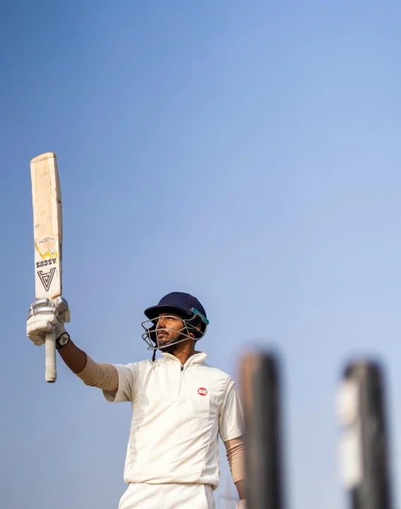 a man holding a bat on top of a field, inspired by Mitchell Johnson, pexels contest winner, white helmet, calcutta, triumphant pose, profile image