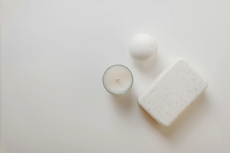 a bar of soap next to a glass of milk, unsplash, minimalism, candle wax, background image, background white, full-body