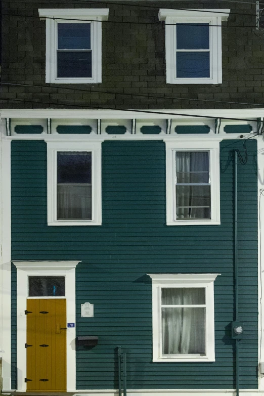 a yellow fire hydrant sitting in front of a green house, inspired by Edward Hopper, fantastic realism, picton blue, panoramic shot, ( ( photograph ) ), long street