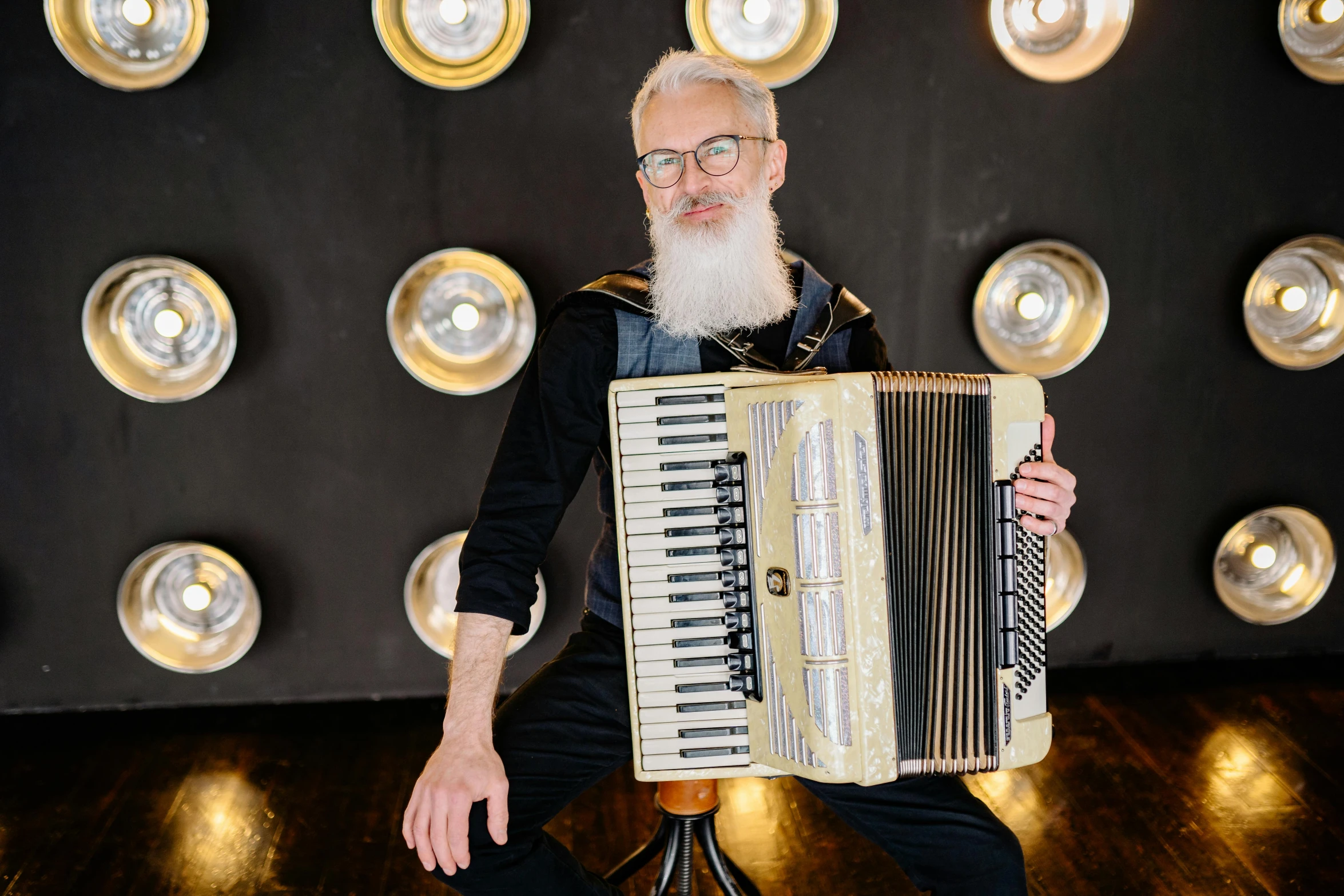 a man with a beard playing an accordion, by Julia Pishtar, white hair and white beard, portrait image, looking towards camera, backdrop