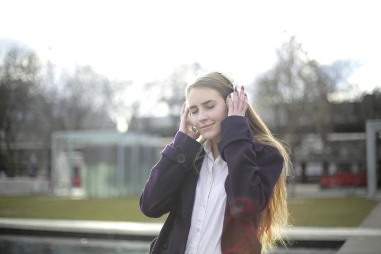 a beautiful young woman talking on a cell phone, an album cover, unsplash, schools, beautifully daylight, greeting hand on head, in london