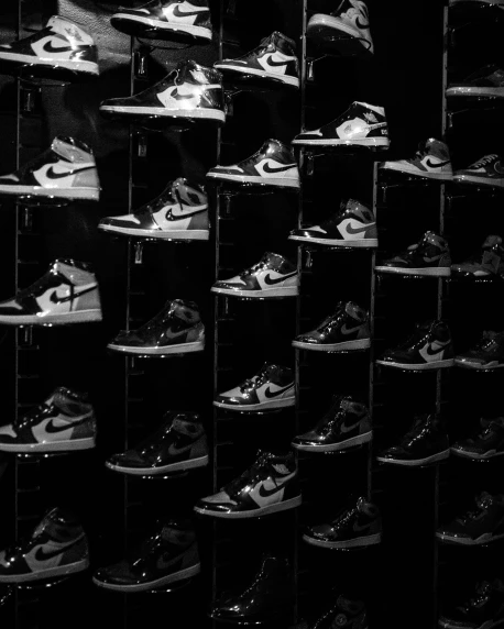 a black and white photo of a wall of shoes, a black and white photo, unsplash, renaissance, “air jordan 1, squares, glazed, nigth