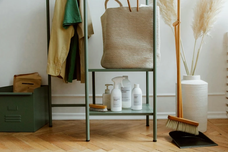 a basket sitting on top of a shelf next to a broom, plasticien, skincare, off - white collection, foreground focus, scandinavian style