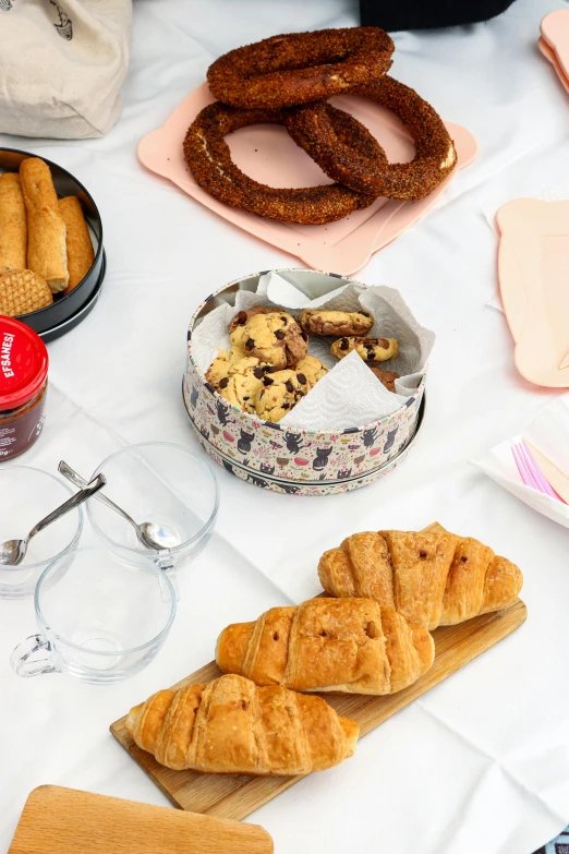 a table topped with croissants and pretzels, collection product, overview, kek, hearty breakfast