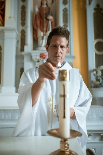a priest lighting a candle in a church, a portrait, by Jan Tengnagel, unsplash, film still of ryan reynolds, white robe with gold accents, 15081959 21121991 01012000 4k, lgbtq