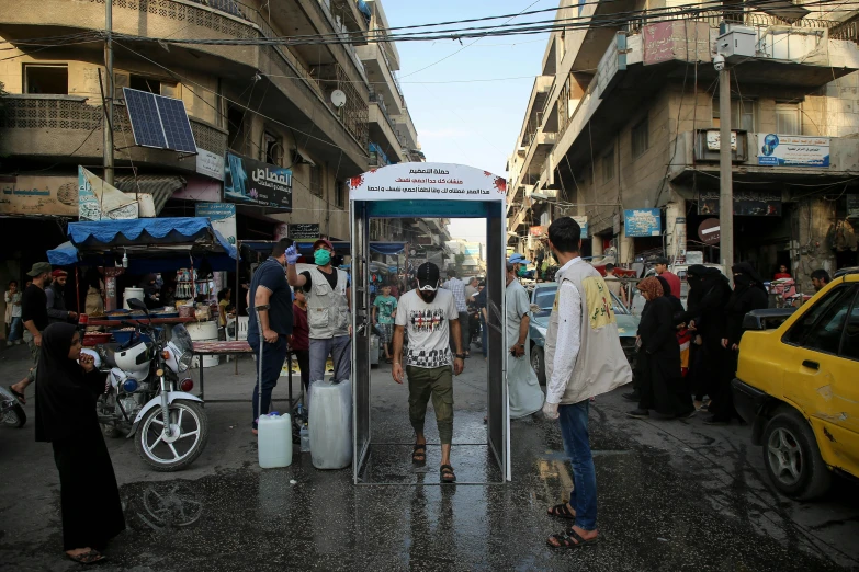 a group of people standing in front of a phone booth, dau-al-set, bustling city, 3 meters, from the distance, riot shields