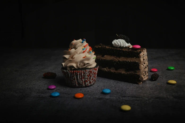 a piece of cake sitting next to a piece of chocolate cake, pexels, colourful cupcake, dark and dim, background image, detailed product shot