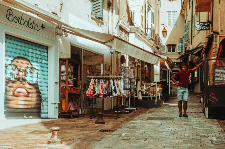 a man walking down a street past shops, by Julia Pishtar, pexels contest winner, renaissance, summer street near a beach, young greek man, in retro colors, in a square