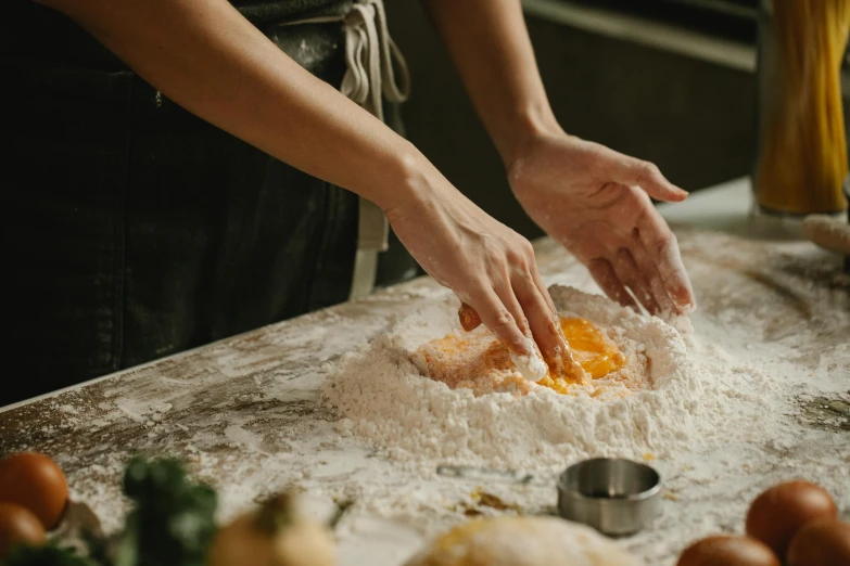 a close up of a person preparing food on a table, covered in white flour, profile image, fan favorite, professional image