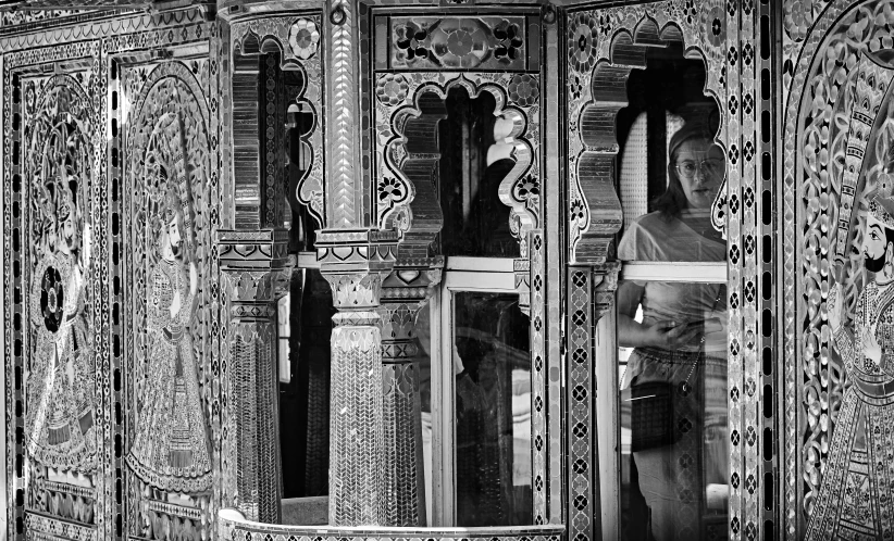 a black and white photo of a woman standing in a room, by Patrick Pietropoli, arabesque, intricately detailed buildings, looking in mirror, part of the screen, shrines