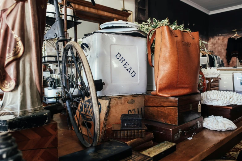 a pile of luggage sitting on top of a wooden table, bakery, botanicals, iconic design, cart