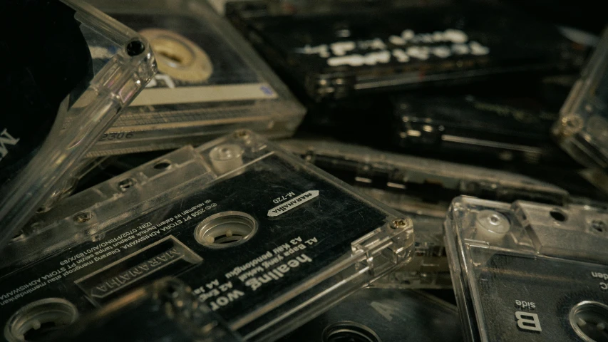a pile of cassettes sitting on top of each other, unsplash, old footage, hans zimmer soundtrack, studio shot, high angle close up shot