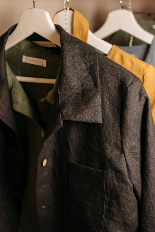 a group of men's shirts hanging on a rack, unsplash, renaissance, charcoal and yellow leather, wearing a linen shirt, open jacket, thumbnail