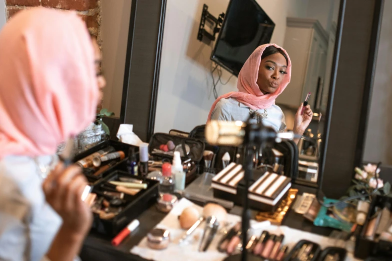 a woman that is standing in front of a mirror, hurufiyya, in professional makeup, riyahd cassiem, a wide shot, bottom angle