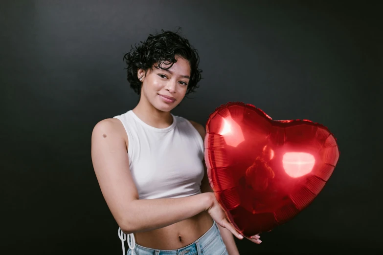 a woman holding a red heart shaped balloon, tessa thompson inspired, nonbinary model, very reflective, light skin