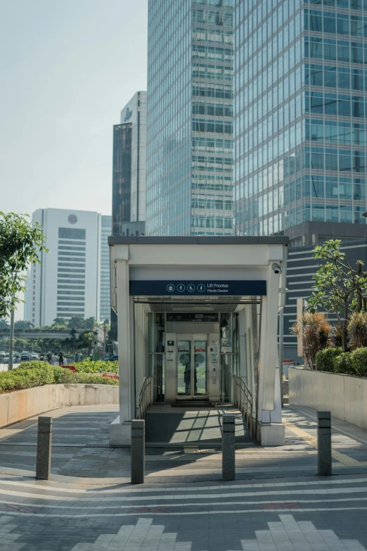 a bus stop on a city street with tall buildings in the background, inspired by Asai Chū, unsplash, sōsaku hanga, exterior botanical garden, facing front, skybridge towers, neoclassical police station