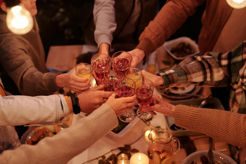 a group of people clinking glasses of wine, by Carey Morris, pexels contest winner, hygge, harvest, mid night, hand on table