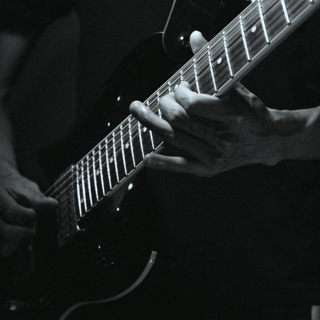 a black and white photo of a person playing a guitar, inspired by John McLaughlin, pexels contest winner, hyperdetailed!, (night), staggered depth), band