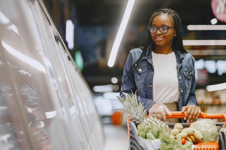 a woman holding a shopping cart in a grocery store, pexels contest winner, black teenage girl, local foods, avatar image, ad image