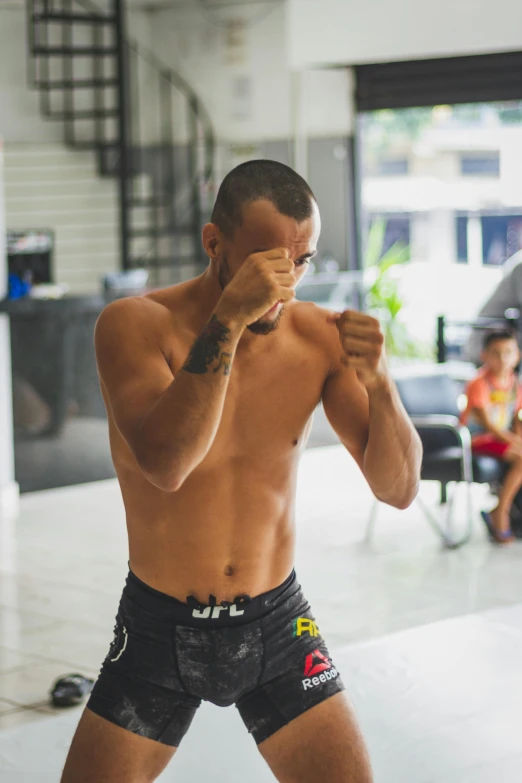 a man that is standing in the middle of a boxing ring, inspired by Nathan Oliveira, mma southpaw stance, profile image, bangkok, square