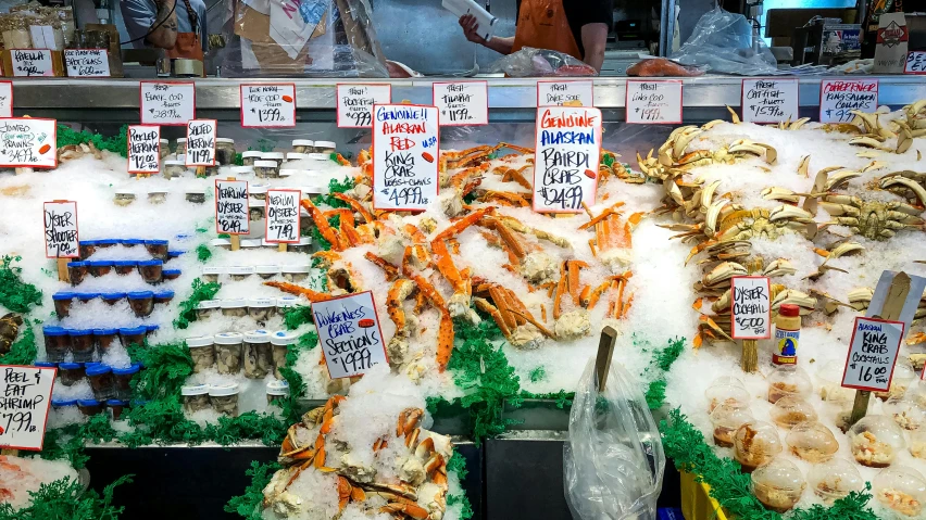 a display case filled with lots of different types of seafood, a photo, by Meredith Dillman, unsplash, fan favorite, market stalls, huge crab, by greg rutkowski