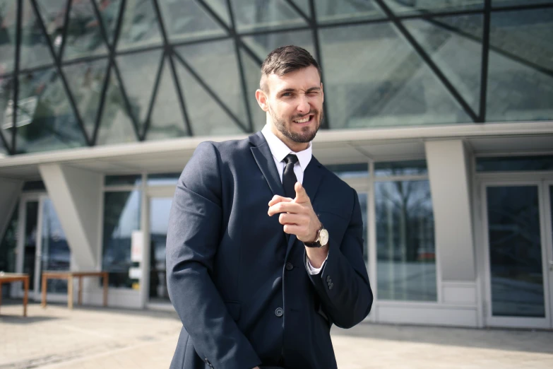 a man in a suit standing in front of a building, inspired by Ivan Lacković Croata, pexels contest winner, smiling male, ready for a meeting, professional sports style, profile image