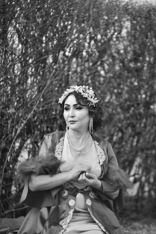 a black and white photo of a woman in a dress, inspired by irakli nadar, unsplash, renaissance, gypsy, dressed in laurel wreath, furr covering her chest, set photograph in costume