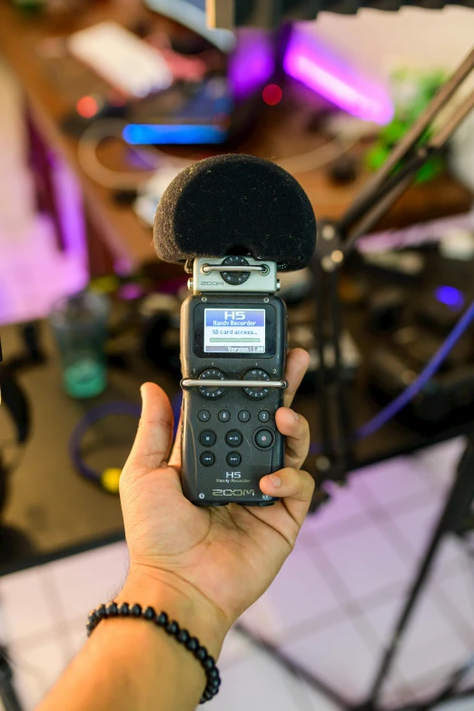 a person holding a microphone in their hand, by Robbie Trevino, reddit, bodycam, panoramic shot, studio recording, avatar image