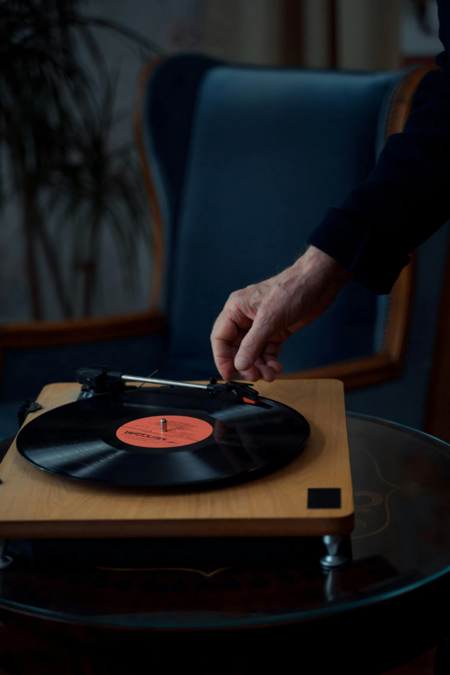 a person playing a record on a record player, by Ottó Baditz, detailed product image, on a wooden tray, lossless quality, vertical orientation