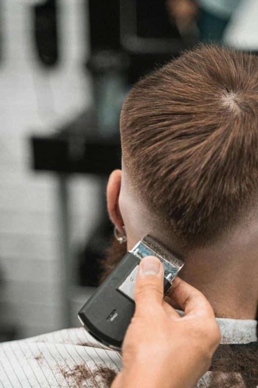 a man getting his hair cut at a barber shop, a stipple, trending on pexels, back shark fin, high collar, rectangle, buzz cut