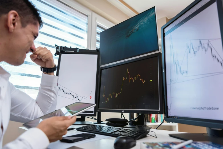 a man sitting at a desk in front of two computer monitors, pexels, analytical art, trading stocks, mathematical, instagram picture, no - text no - logo